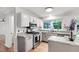 Modern kitchen includes granite countertops, stainless steel appliances, and bright lighting at 1412 Amberton Ct, Raleigh, NC 27615