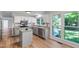 This is the updated kitchen featuring white cabinets, granite countertops and an island at 1412 Amberton Ct, Raleigh, NC 27615