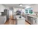 Updated kitchen with an island, granite countertops, stainless appliances, white cabinets, and a view at 1412 Amberton Ct, Raleigh, NC 27615