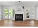 Bright living room with a fireplace, back deck access, and plenty of light at 1412 Amberton Ct, Raleigh, NC 27615