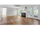 Spacious living room boasts wood floors, fireplace, and access to the back deck at 1412 Amberton Ct, Raleigh, NC 27615