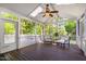 Relaxing screened porch featuring wooden floors and comfortable seating with views of the green backyard at 1412 Amberton Ct, Raleigh, NC 27615