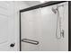 Modern shower with black trim, glass door, and adjustable shower head at 1412 Amberton Ct, Raleigh, NC 27615