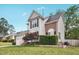 Exterior view of the two-story home featuring gray siding, brick accents, and landscaped yard at 145 Richmond Park Dr, Cameron, NC 28326
