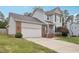 Two-story home with gray siding, brick accents, attached garage and manicured front lawn at 145 Richmond Park Dr, Cameron, NC 28326