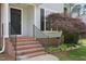 Front porch of the home with brick steps, black front door, and a charming Japanese maple tree at 145 Richmond Park Dr, Cameron, NC 28326
