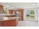 Eat-in kitchen with stainless appliances, wood cabinets, and tiled floors at 145 Richmond Park Dr, Cameron, NC 28326
