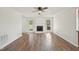 Living room with hardwood floors, a white brick fireplace, and access to the backyard at 145 Richmond Park Dr, Cameron, NC 28326