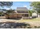 Back of brick home with a screened-in porch and a spacious fenced-in yard at 192 Crestdale Dr, Clayton, NC 27520