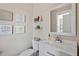 Bright bathroom with vanity sink, toilet, framed mirror, and inspirational wall art at 192 Crestdale Dr, Clayton, NC 27520