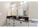 Bathroom features a double vanity with black granite countertop and large mirror at 192 Crestdale Dr, Clayton, NC 27520