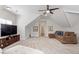 Spacious bonus room with plush carpeting, ceiling fan, and comfortable seating area, perfect for entertaining at 192 Crestdale Dr, Clayton, NC 27520
