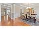 Formal dining room featuring a stylish chandelier, wainscoting, and hardwood floors at 192 Crestdale Dr, Clayton, NC 27520