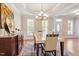 Formal dining room with bright windows, hardwood floors, and elegant chandelier at 192 Crestdale Dr, Clayton, NC 27520