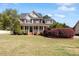 Charming two-story brick home featuring a welcoming front porch and lush landscaping at 192 Crestdale Dr, Clayton, NC 27520