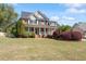 Charming two-story brick home featuring a welcoming front porch and lush landscaping at 192 Crestdale Dr, Clayton, NC 27520