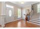 Inviting foyer with hardwood floors, elegant staircase, and decorative front door at 192 Crestdale Dr, Clayton, NC 27520