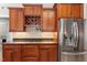 Cherry wood cabinets include a wine rack above the stainless steel refrigerator at 192 Crestdale Dr, Clayton, NC 27520