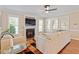 Cozy living room with a fireplace, large windows, and comfortable seating area at 192 Crestdale Dr, Clayton, NC 27520