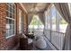 Relaxing screened-in porch featuring cozy seating, ceiling fan, and natural light at 192 Crestdale Dr, Clayton, NC 27520