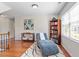 Inviting sitting area with hardwood floors, a comfy chaise lounge, and a bookshelf at 192 Crestdale Dr, Clayton, NC 27520