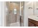 Shower enclosure featuring tile surround, built-in seat and glass door at 2027 Hayes Ln, Holly Springs, NC 27540