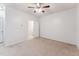 Neutral bedroom with a ceiling fan and neutral walls and carpet at 2027 Hayes Ln, Holly Springs, NC 27540