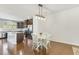 Dining area featuring hardwood floors, modern lighting, and seamless access to the kitchen at 2027 Hayes Ln, Holly Springs, NC 27540