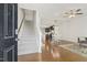 Bright entryway showcasing hardwood floors and staircase leading to upper level, with open layout to the dining at 2027 Hayes Ln, Holly Springs, NC 27540