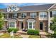 Charming brick townhome with a cozy front porch and well-maintained landscaping at 2027 Hayes Ln, Holly Springs, NC 27540