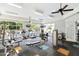 Bright gym featuring exercise equipment, mounted TVs, ceiling fans, and large windows offering outdoor views at 2027 Hayes Ln, Holly Springs, NC 27540