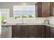 Bright kitchen featuring granite countertops, stainless steel appliances, and a garden view at 2027 Hayes Ln, Holly Springs, NC 27540