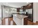 A kitchen featuring stainless steel appliances, granite countertops, and dark wood cabinets at 2027 Hayes Ln, Holly Springs, NC 27540