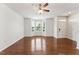 Sunlit living room featuring hardwood floors, a ceiling fan, and natural light at 2027 Hayes Ln, Holly Springs, NC 27540