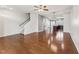 Spacious open-concept living area with hardwood floors and staircase at 2027 Hayes Ln, Holly Springs, NC 27540