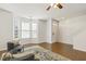 Inviting living room featuring hardwood floors, large windows, and comfortable seating at 2027 Hayes Ln, Holly Springs, NC 27540