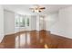 Open-concept living room with gleaming hardwood floors and plenty of natural light at 2027 Hayes Ln, Holly Springs, NC 27540