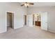 Main bedroom with ceiling fan and doorways to bathroom and walk-in closet at 2027 Hayes Ln, Holly Springs, NC 27540