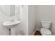 Clean and bright powder room with pedestal sink, and modern fixtures at 2027 Hayes Ln, Holly Springs, NC 27540