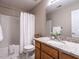 Bathroom with granite counters, white vanity, white tile floors and bath tub with shower at 207 Reedhaven Dr, Cary, NC 27513