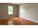 Bedroom with hardwood floors, one window, and neutral paint at 207 Reedhaven Dr, Cary, NC 27513