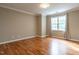 Bright bedroom featuring hardwood floors and a large window with natural light at 207 Reedhaven Dr, Cary, NC 27513
