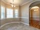 A dining room features a decorative light fixture, archway and large windows at 207 Reedhaven Dr, Cary, NC 27513