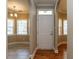 Inviting foyer with hardwood floors, arched doorways, and views of the dining room and living spaces at 207 Reedhaven Dr, Cary, NC 27513