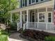 Inviting front porch with classic white columns and landscaping at 207 Reedhaven Dr, Cary, NC 27513