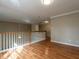 Upstairs hallway with wood floors, natural light and wood railing at 207 Reedhaven Dr, Cary, NC 27513