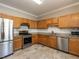 Modern kitchen with stainless steel appliances, granite countertops, tile backsplash, and ample cabinet storage at 207 Reedhaven Dr, Cary, NC 27513