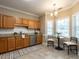 Bright kitchen with tile floors, stainless appliances, and dining area at 207 Reedhaven Dr, Cary, NC 27513