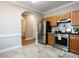 Cozy kitchen with stainless steel appliances and stone tile flooring at 207 Reedhaven Dr, Cary, NC 27513