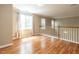 Open landing area featuring hardwood floors, natural light, and neutral wall colors at 207 Reedhaven Dr, Cary, NC 27513